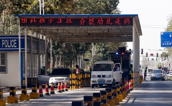 Vehicles belonging to Uighur drivers being inspected at a police checkpoint in the Xinjiang region.