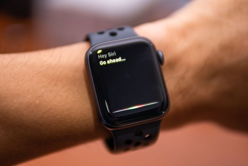 An Apple Watch on a person's wrist, with the Siri voice assistant activated.
