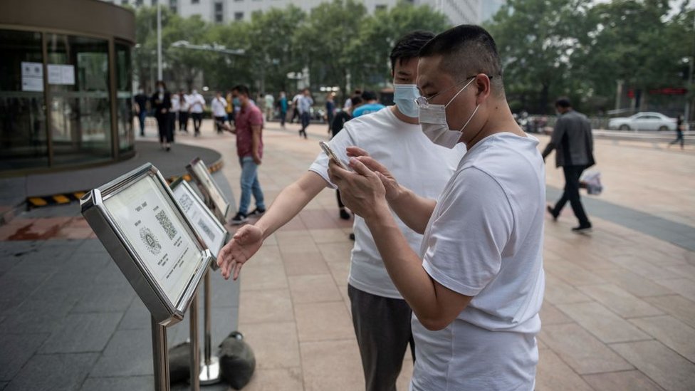 Men in China using QR codes.